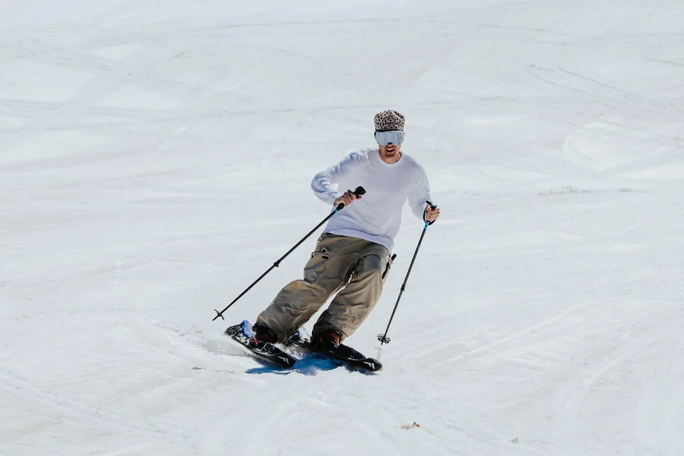 A rider carving a turn on Frigid Dynamics E-XC electric skis